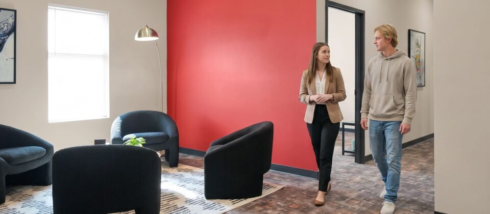 A staff member greets a client in the welcoming lounge area at our dual diagnosis treatment center in Indiana, where comprehensive care begins with a warm, personal connection