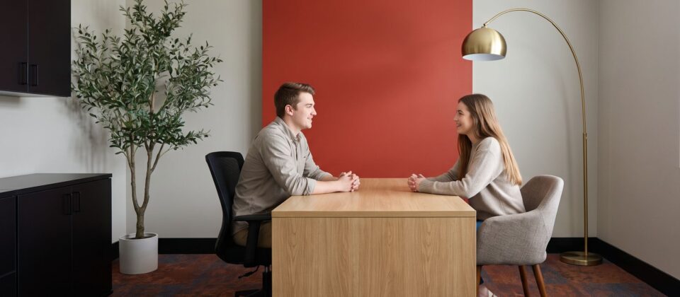 Client and counselor discussing Oxycodone addiction during office consultation