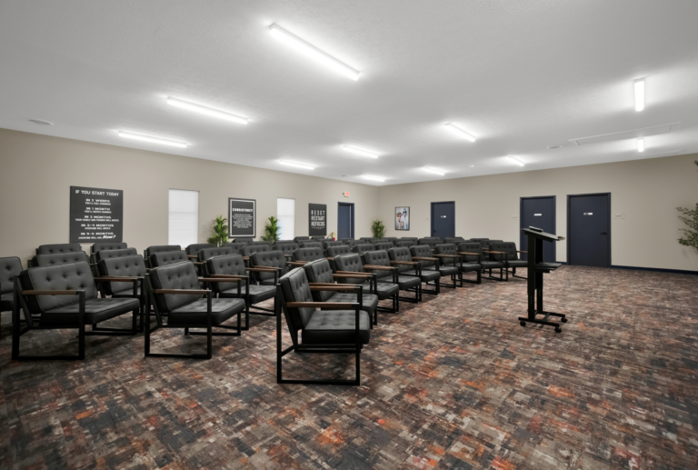 Comfortable addiction recovery support group room with seating and motivational posters.