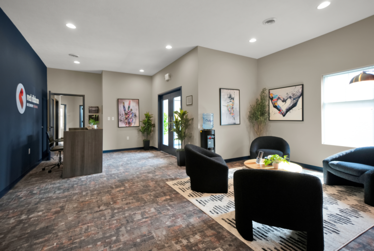 Comfortable addiction recovery center waiting area with modern decor and artwork.