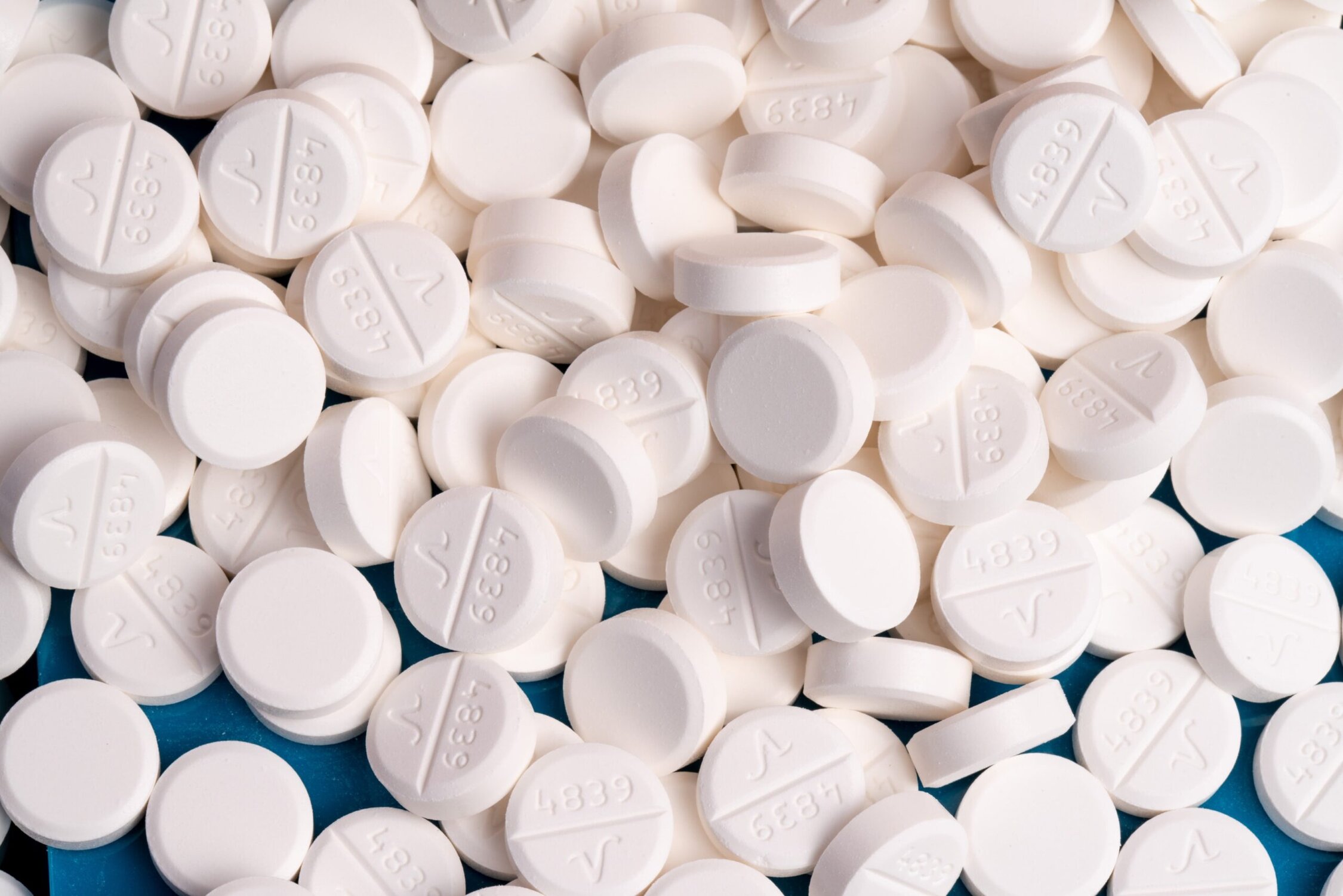 White prescription pills for opioid addiction treatment, medication for recovery, opioid recovery, addiction management pills.