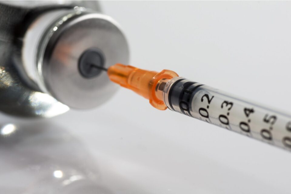 Vaccine syringe with needle for immunization and health treatment.