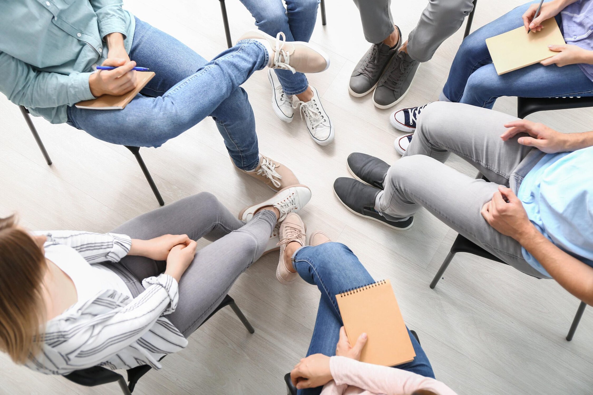 Support group therapy session with diverse participants sharing experiences and insights.