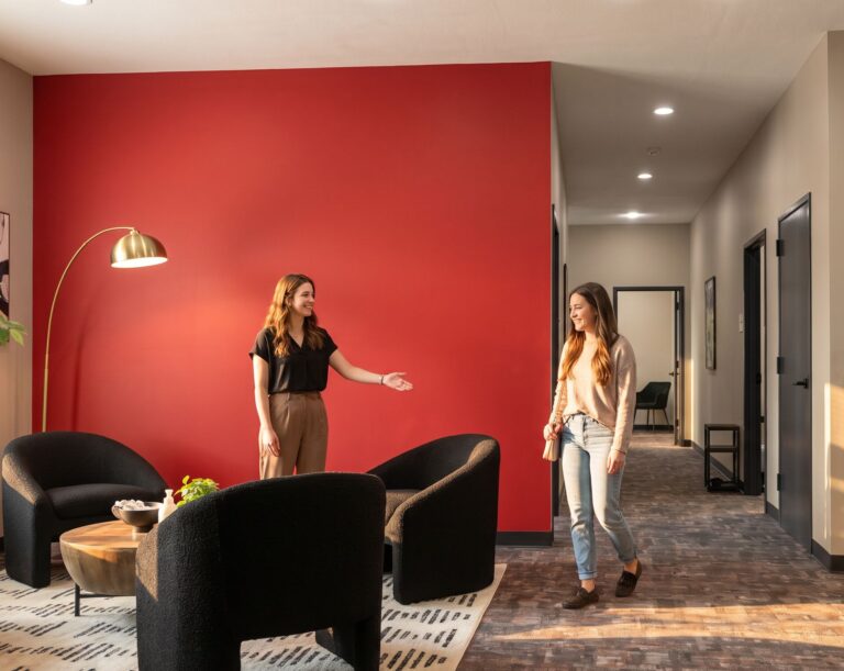 Staff member welcoming new client into lounge area at drug rehab Indiana facility