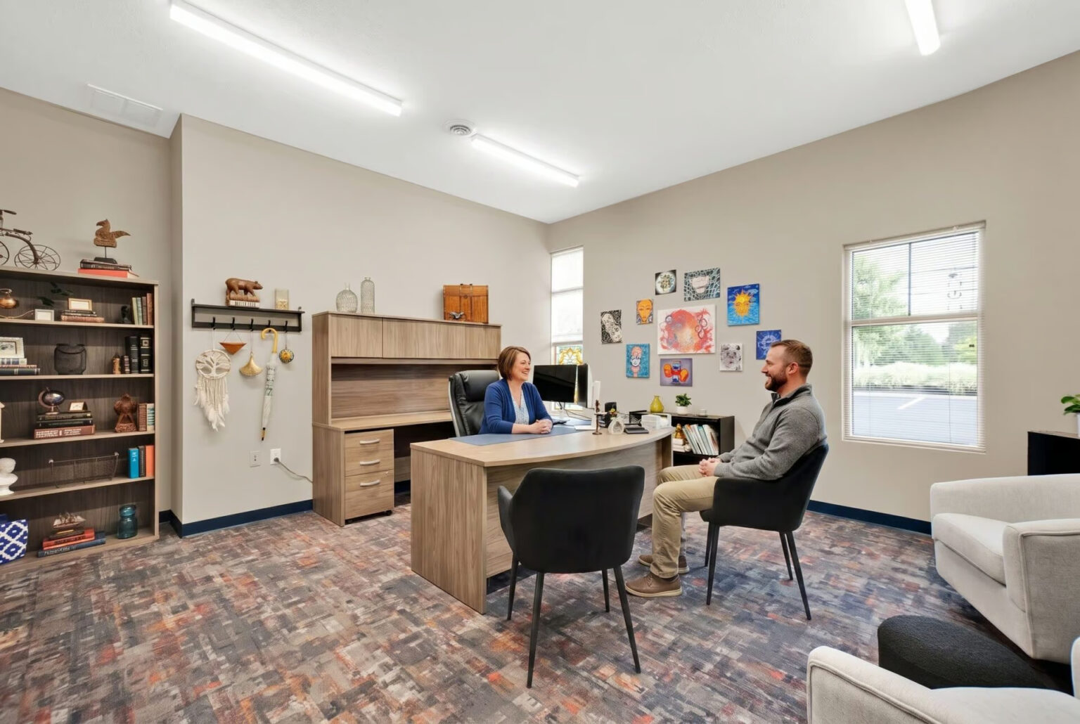 Addiction treatment center in Indiana with a counselor and client having a supportive recovery discussion.